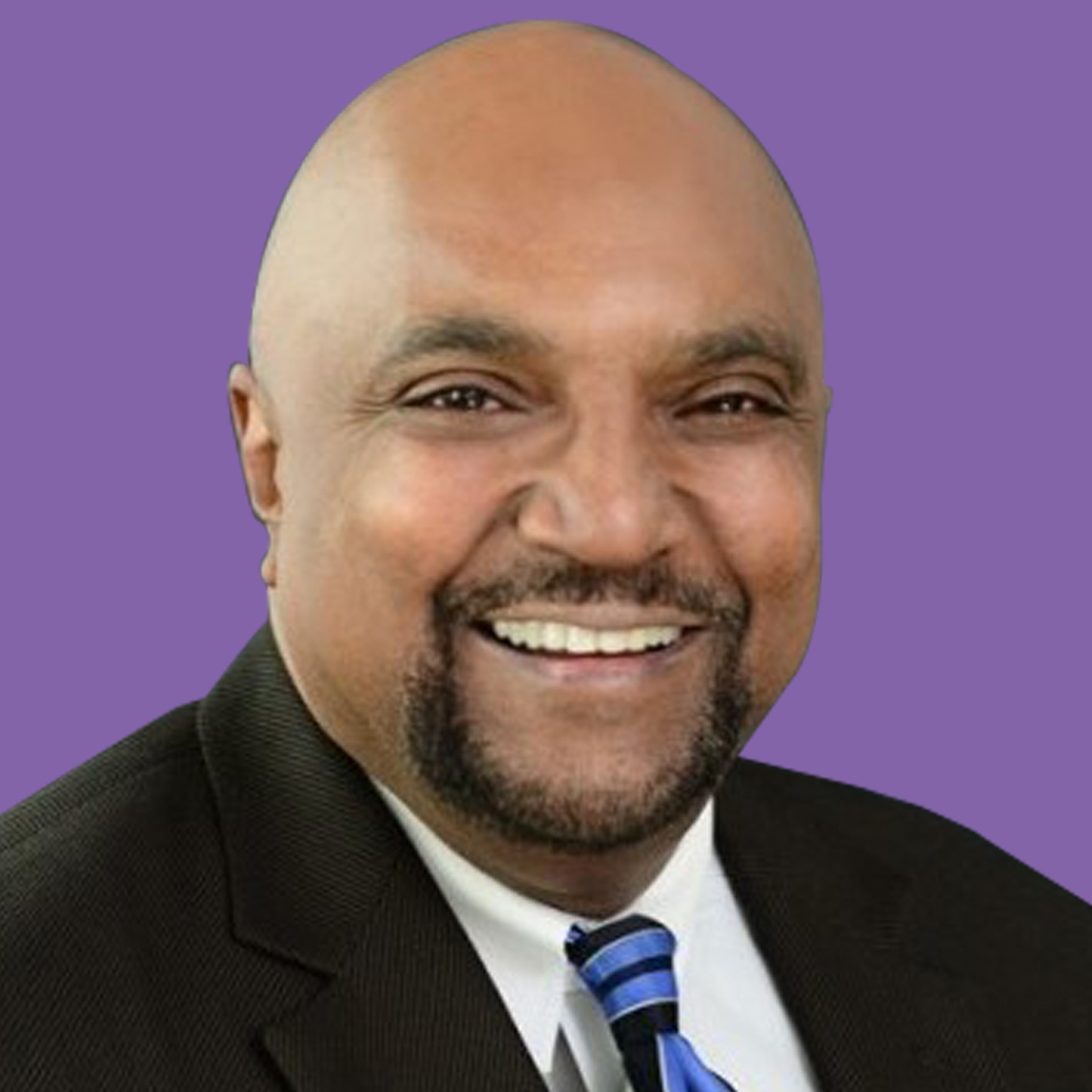 Smiling individual in a suit with a blue and white striped tie against a purple background, conveying positivity and professionalism.